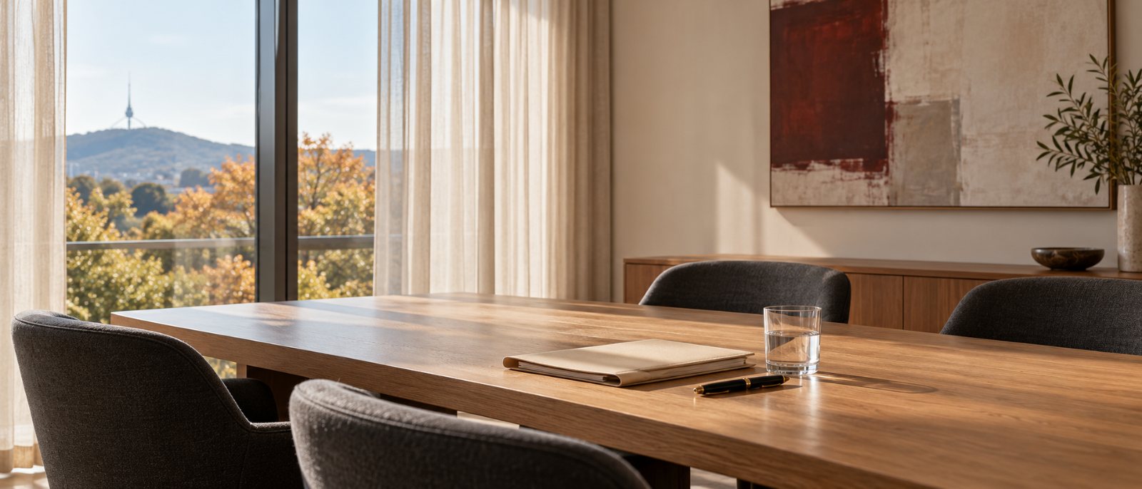 A quiet consultation room with an oak table and soft daylight